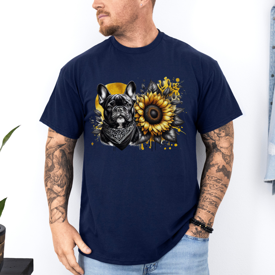 A man wearing a navy graphic t-shirt featuring a French Bulldog and a sunflower design, paired with light blue jeans against a white wall. Grab your tee from Coffee and Moo NZ.