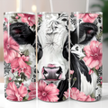 Floral Friesian Cow tumbler shown in three views, featuring a black and white Friesian cow surrounded by pink flowers, green leaves and decorative floral patterns, from Coffee & Moo.