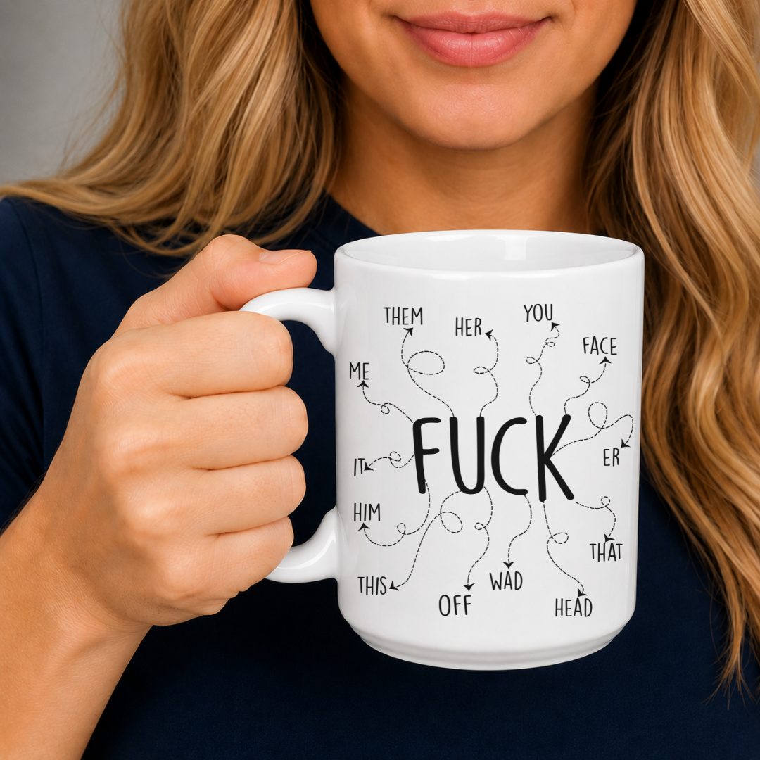 A woman holding a white ceramic mug with a black graphic print featuring the word 'FUCK' surrounded by words like 'THEM', 'HER', 'YOU', 'FACE', 'IT', 'HIM', 'THIS', 'OFF', 'WAD', 'THAT', and 'HEAD'. From Coffee and Moo NZ.