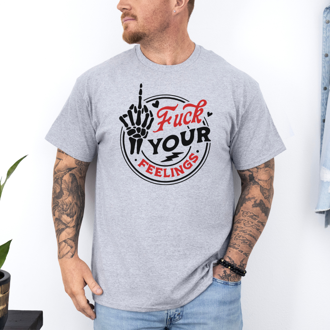 A man wearing a heather gray t-shirt with a graphic that reads 'Fuck YOUR FEELINGS' in red and black, featuring a hand gesture. purchase from coffee and moo NZ.
