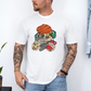 Male wearing a white graphic T-shirt  featuring a colorful cartoon sloth wearing an orange knit beanie, green headphones, while holding a red phone and grey controller. Grab your tee from Coffee and Moo NZ.