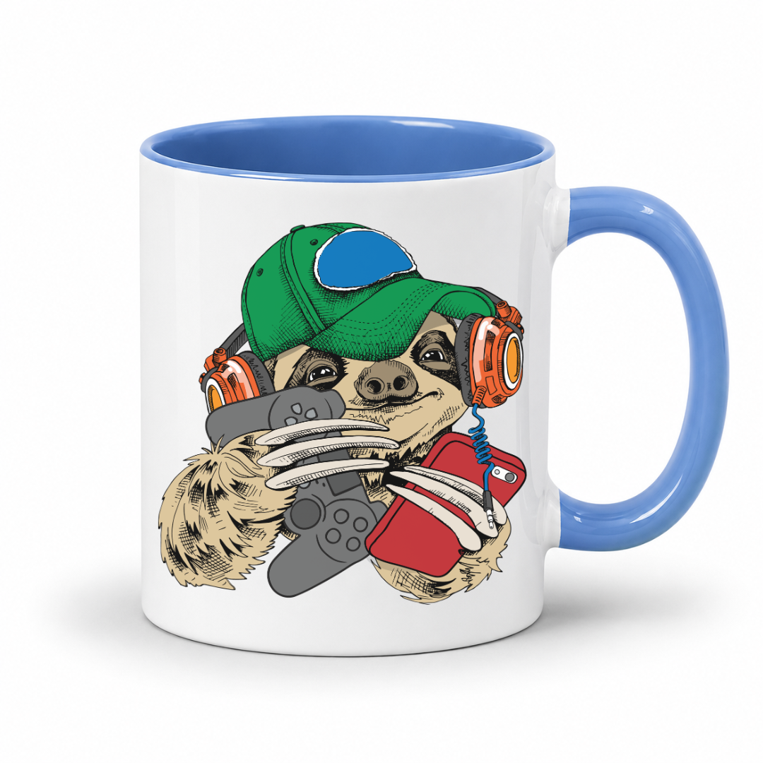A white ceramic mug with a blue interior and handle, featuring a cartoon sloth graphic wearing a green cap, orange headphones, and holding a grey controller and red phone. Purchase your mug from Coffee and Moo NZ.
