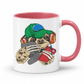 A white ceramic coffee mug with a pink interior and handle, featuring a cartoon sloth wearing a green cap and orange headphones while holding a red phone and grey game controller. Purchase your mug from Coffee and Moo NZ.