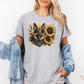 A man wearing a grey short-sleeve t-shirt with a graphic print of a German Shepherd dog surrounded by yellow sunflowers, paired with light blue jeans. Grab your tee from Coffee and Moo NZ.