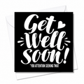 A square black greeting card with white script text reading 'Get Well Soon!' and smaller text '*YOU ATTENTION SEEKING TWAT', shown with white envelopes behind it on a white background. Grab your from Coffee and Moo NZ.