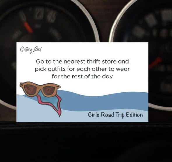 A card from the 'Getting Lost Girls Road Trip Edition' game. card reads "Go to the nearest thrift store and pick outfits for each other to wear for the rest of the day". Pack Includes 26 direction and activity cards, ready for a weekend getaway. Purchase yours from Coffee and Moo NZ