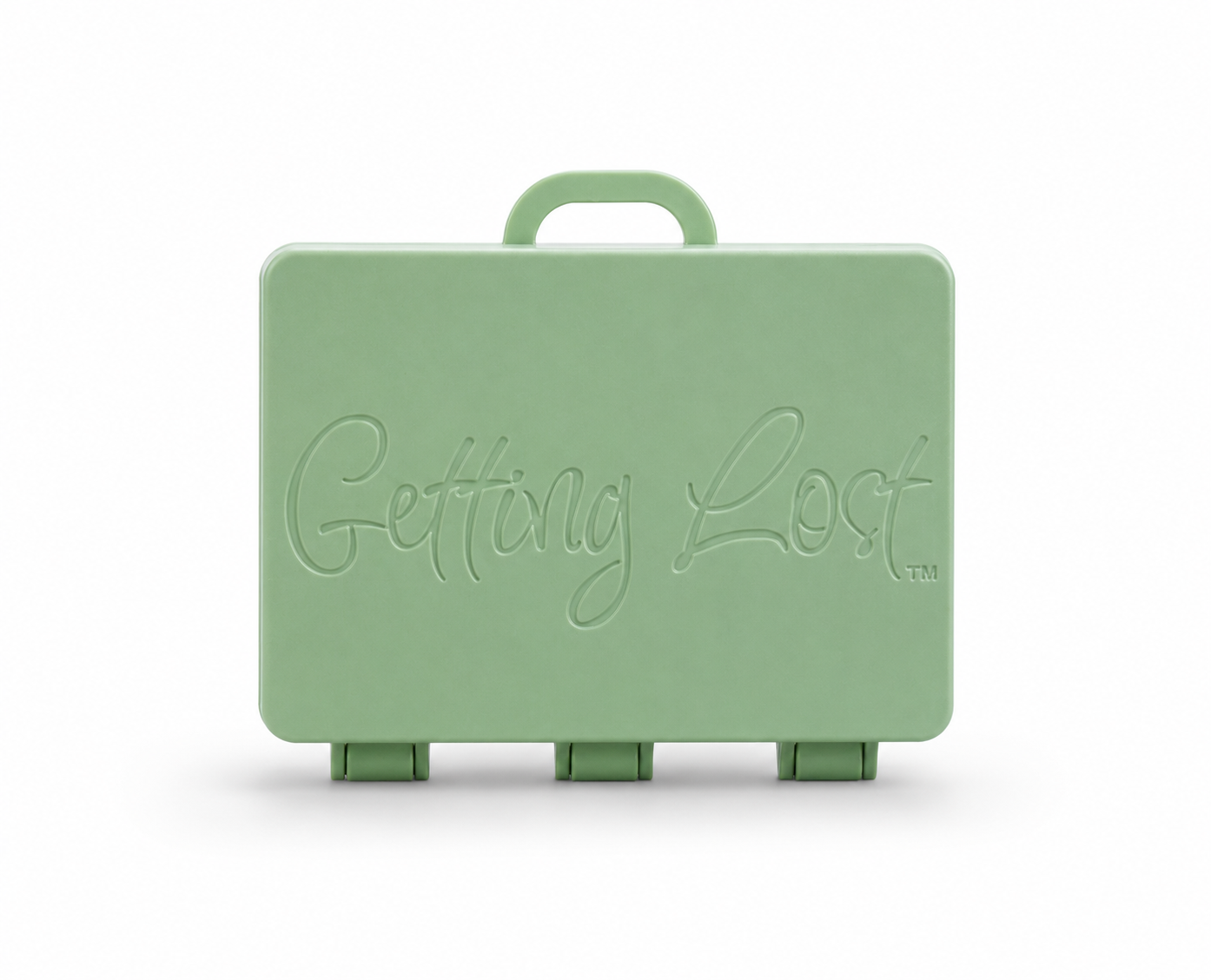 A moss green rectangular carrying case with a top handle, featuring the words 'Getting Lost' embossed on the front, set against a plain white background. For the Getting lost card game. Purchase from Coffee and Moo