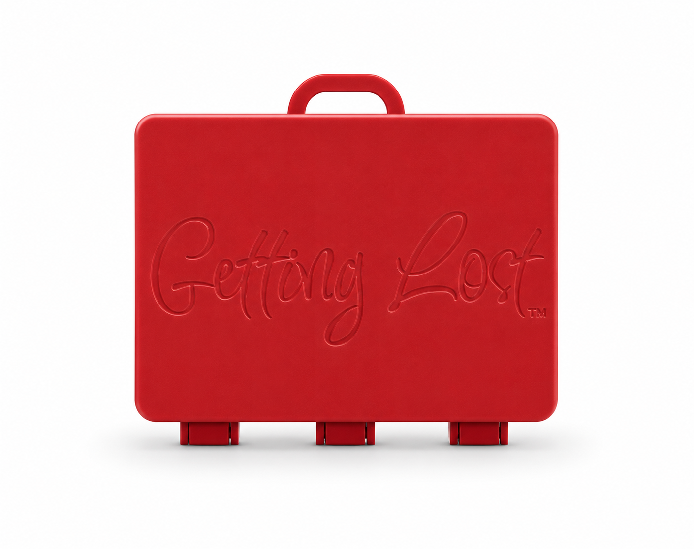 A red rectangular carrying case with a top handle, featuring the words 'Getting Lost' embossed on the front, set against a plain white background. For the Getting lost card game. Purchase from Coffee and Moo
