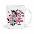 A white ceramic mug featuring a cartoon donkey graphic and the text 'Giddy Up Sparkle Farts There's Chaos to Spread.' on a clean white background. from Coffee and Moo.