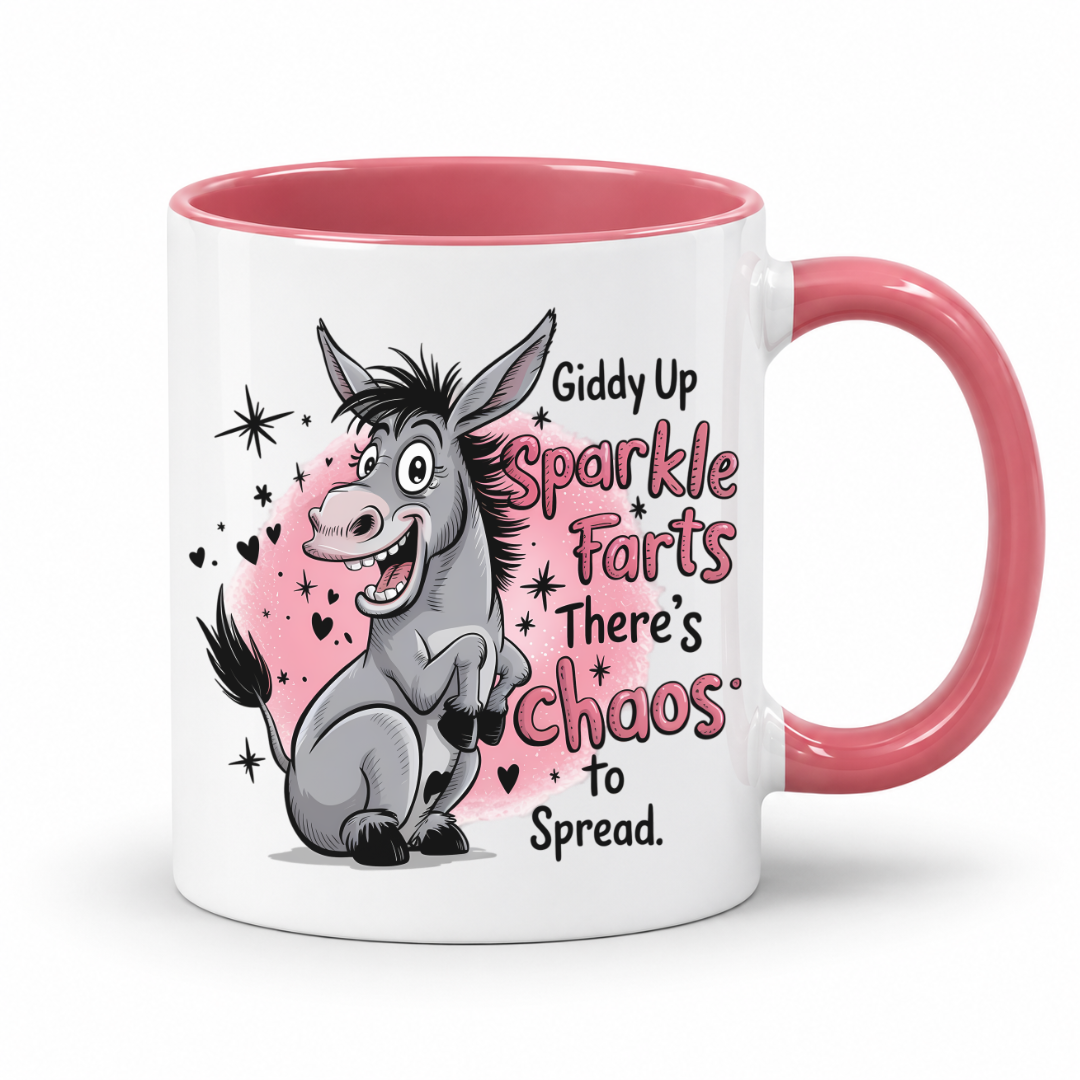 A white ceramic mug with a pink interior and handle, featuring a cartoon donkey graphic and the text 'Giddy Up Sparkle Farts There's Chaos to Spread.' on a clean white background. from Coffee and Moo.