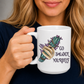 A woman holding a white ceramic mug with a graphic of a hand holding a green and purple smudge bundle next to the text 'GO SMUDGE YOURSELF'. Purchase from Coffee and Moo NZ.