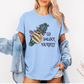 A woman wearing a light blue graphic t-shirt with a smudge bundle and the text 'GO SMUDGE YOURSELF' printed on the front, styled with an open light-wash denim jacket. Purchase from Coffee and Moo NZ.