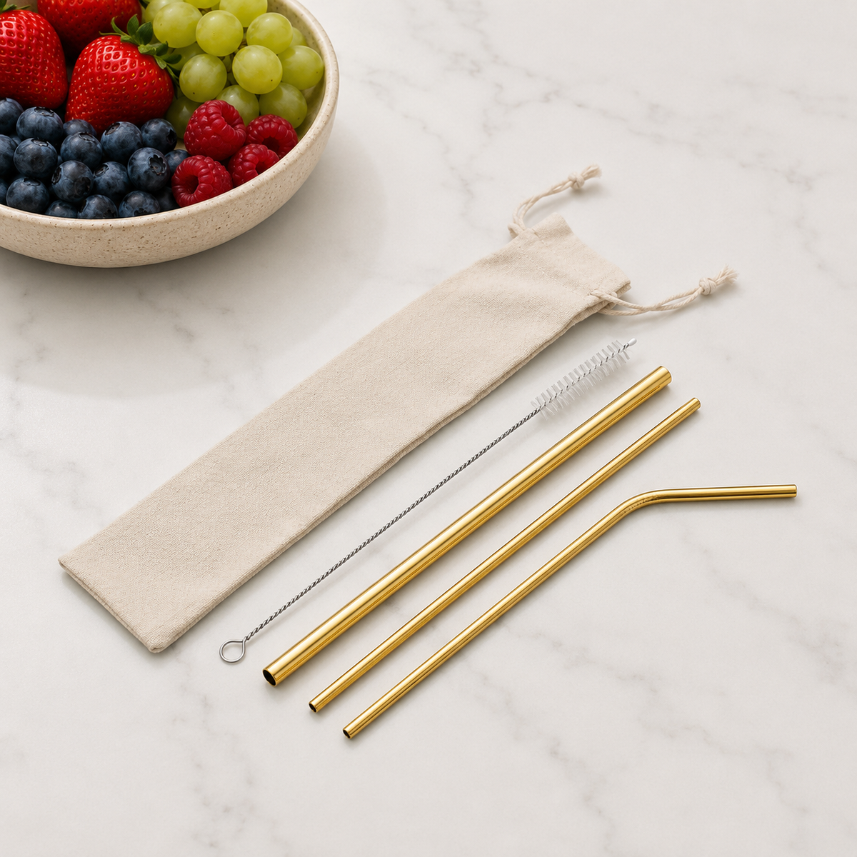 Gold reusable stainless steel straw set with three different straw styles, cleaning brush and beige drawstring pouch. From coffee and moo nz.