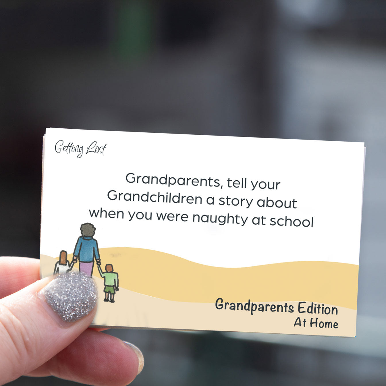 "Getting lost" grandparents edition card game. featuring 30 double sided activity + direction cards. image shows a card from the game with the text " Grandparent, tell your grandchildren a story about when you were naughty at school. Grab yours pack from Coffee and Moo NZ.,