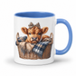 A white ceramic mug with a blue interior and handle, featuring a printed illustration of a brown calf sitting in a wicker basket with a plaid blanket and leopard-print bow. from Coffee and Moo.