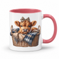 A white ceramic mug with a pink interior and handle, featuring a printed illustration of a brown calf in a wicker basket with a plaid blanket and leopard-print bow. from Coffee and Moo NZ.