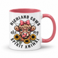 A white ceramic mug with a pink interior and handle, featuring a cartoon illustration of a Highland cow wearing round glasses and a pink bow, surrounded by sunflowers and the text 'HIGHLAND COWS are my SPIRIT ANIMAL'. from Coffee and Moo NZ.