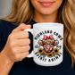 A person holding a white ceramic mug with a graphic of a Highland cow wearing a pink bow, surrounded by sunflowers and the text 'HIGHLAND COWS are my SPIRIT ANIMAL'. from Coffee and Moo NZ.