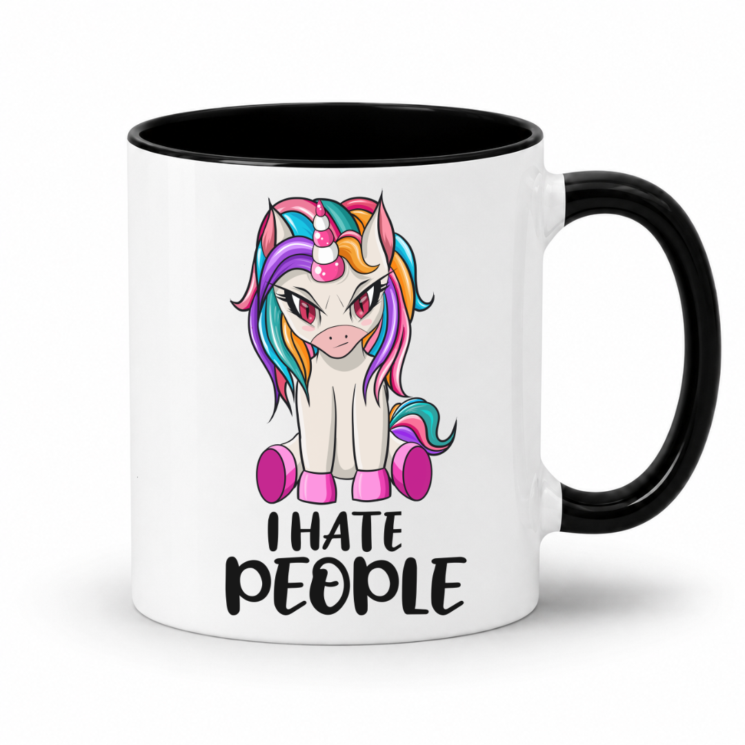 A white ceramic mug with a black handle and black interior, featuring a cartoon unicorn graphic with rainbow-colored hair and the text 'I HATE PEOPLE' printed below. From Coffee and Moo NZ.