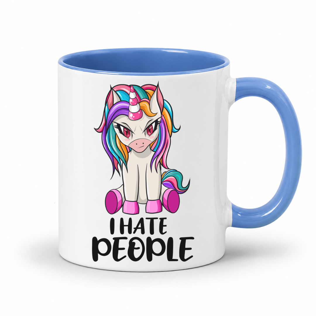 A white ceramic mug with a blue interior and handle, featuring a cartoon unicorn graphic and the text 'I HATE PEOPLE' printed on the front, set against a plain white background. From Coffee and Moo NZ.