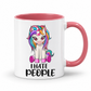A white ceramic mug with a pink interior and handle, featuring a cartoon unicorn graphic with rainbow hair and the text 'I HATE PEOPLE' printed below. From Coffee and Moo NZ.