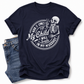 A navy blue short-sleeve t-shirt with a white graphic print of a skeleton and the text 'When it comes to My Child I Will Smile in my mugshot', styled flat-lay next to a pair of blue jeans on a white background. Grab your tee from Coffee and Moo NZ.