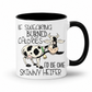 A white ceramic coffee mug with a black interior and black handle, featuring a cartoon cow and the text 'IF SWEARING BURNED CALORIES I'D BE ONE SKINNY HEIFER' on a white background. from Coffee and Moo NZ.
