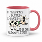 A white ceramic mug with a pink interior and handle, featuring a cartoon cow and the text 'IF SWEARING BURNED CALORIES I'D BE ONE SKINNY HEIFER' on a white background. purchase from Coffee and Moo NZ.