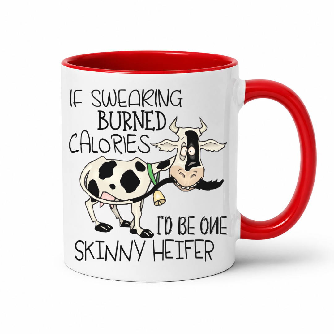 A white ceramic coffee mug with a red interior and red handle, featuring a cartoon cow and the text 'IF SWEARING BURNED CALORIES I'D BE ONE SKINNY HEIFER' on a white background. purchase from Coffee and Moo NZ.