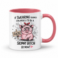 A white ceramic mug with a pink interior and handle, featuring a cartoon pink pig wearing glasses and a bow, holding a sign that reads 'FUCK', with text above and below saying 'IF SWEARING BURNED CALORIES I'D BE A SKINNY BITCH BY NOW!'. from Coffee and Moo.
