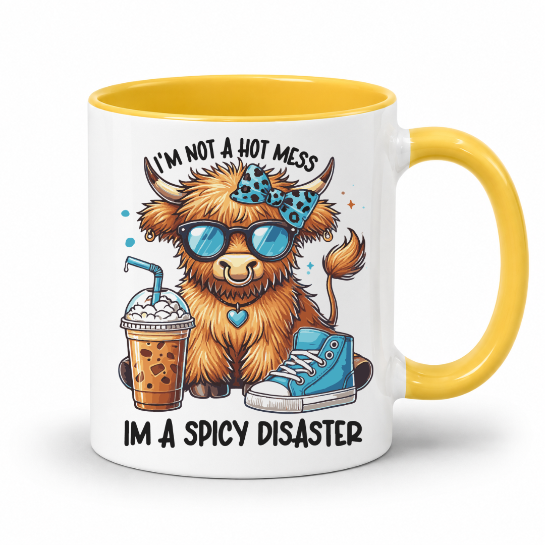A white ceramic coffee mug with a yellow interior and yellow handle, featuring a cartoon highland cow wearing blue sunglasses and a blue bow tie, holding an iced coffee and a blue sneaker, with the text 'I'M NOT A HOT MESS IM A SPICY DISASTER'. from Coffee and Moo NZ.
