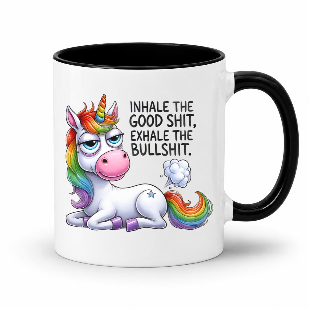 A white ceramic coffee mug with a black handle and black interior, featuring a cartoon rainbow unicorn and the text 'INHALE THE GOOD SHIT, EXHALE THE BULLSHIT.' on a white background. Purchase from Coffee and Moo NZ.