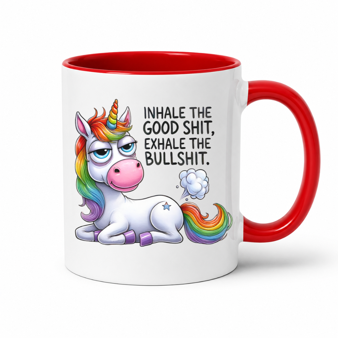 A white ceramic coffee mug with a red interior, red handle, and a colorful cartoon unicorn graphic with the text 'INHALE THE GOOD SHIT, EXHALE THE BULLSHIT.' on a clean white background. Purchase from Coffee and Moo NZ.