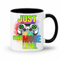 Just One More Level gaming coffee mug showing a colourful controller, rainbow watercolour background and bold "Just One More Level" design, with a black inner and handle, from Coffee and Moo.