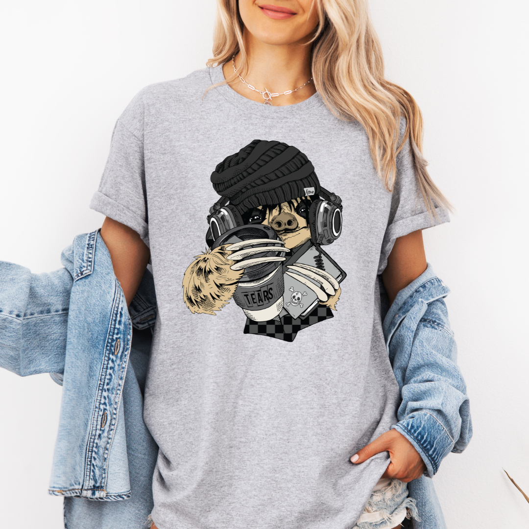 A woman wearing a white short-sleeve graphic t-shirt with a stylized Emo sloth wearing a beanie, headphones, and holding a coffee cup with the word "TEARS" on it. Grab your tee from Coffee and Moo NZ.