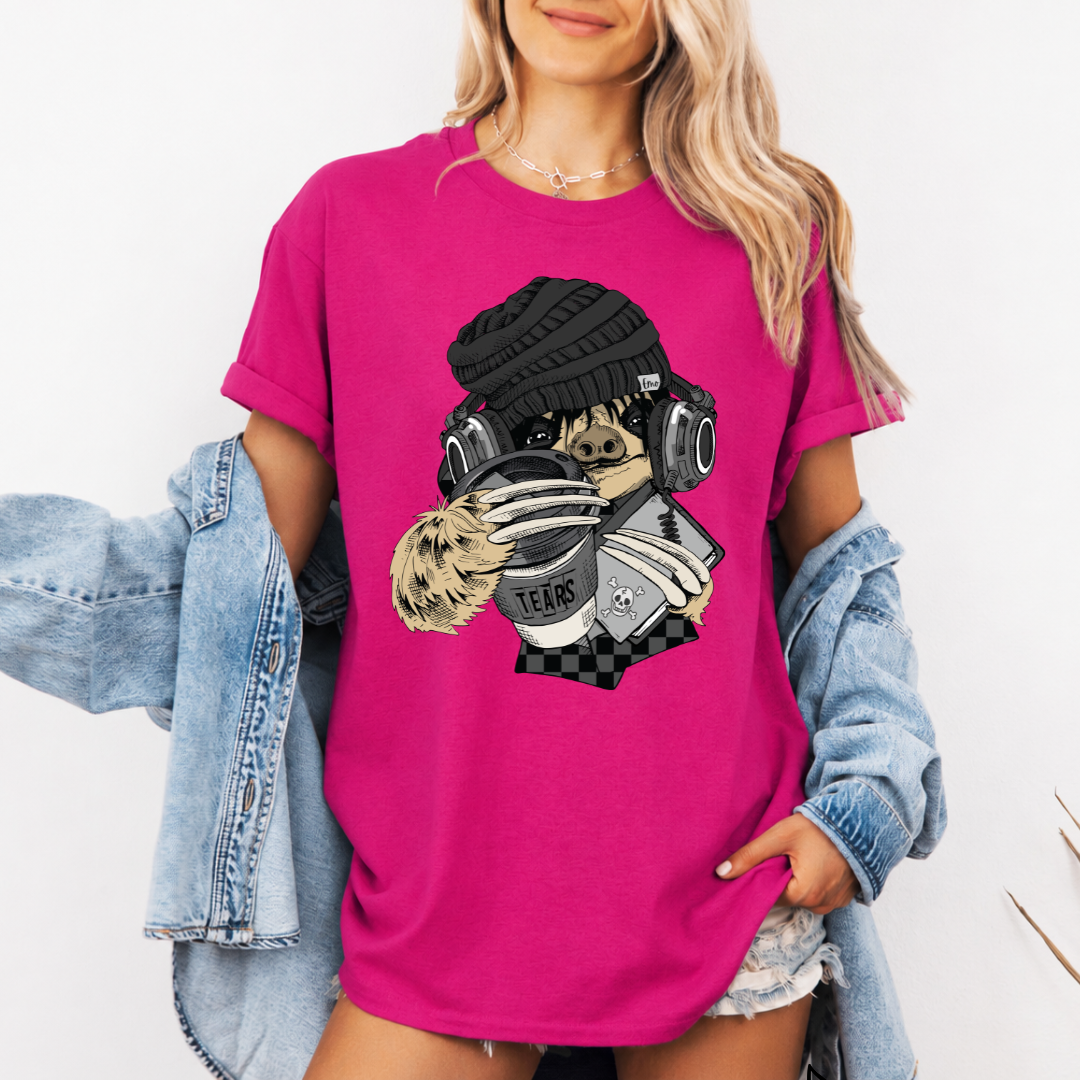 A woman wearing a pink short-sleeve graphic t-shirt with a stylized Emo sloth wearing a beanie, headphones, and holding a coffee cup with the word "TEARS" on it. Grab your tee from Coffee and Moo NZ.