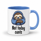 A white ceramic mug with a blue interior, blue handle, and a cartoon sloth wearing a blue hoodie with the text 'Not today cunts' printed below.  from Coffee and Moo.