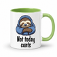 A white ceramic mug with a light green interior and handle, featuring a cartoon sloth in a blue hoodie and the text 'Not today cunts' printed on the front.  from Coffee and Moo.