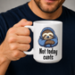 A man holding a white ceramic mug with a cartoon sloth wearing a blue hoodie and the text 'Not today cunts' printed on it. The man is wearing a dark navy blue t-shirt against a neutral gray background.  from Coffee and Moo.
