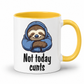 A white ceramic mug with a yellow interior and yellow handle, featuring a cartoon sloth wrapped in a blue hoodie and the text 'Not today cunts' in black lettering.  from Coffee and Moo.
