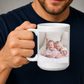 A dad holding a white ceramic mug with a custom printed family photo of three children. Grab your custom photo mug from Coffee and Moo NZ.