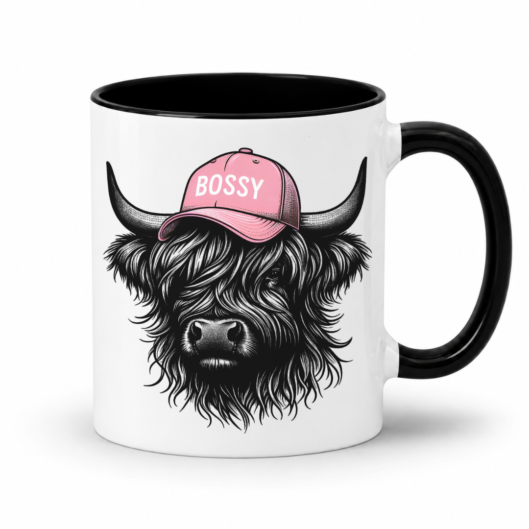 Black handle and inner mug with an image of a black Bossy Highland Cow wearing a Pink Cap. Mug is set on a white background .grab your bossy  mug from Coffee and Moo NZ.