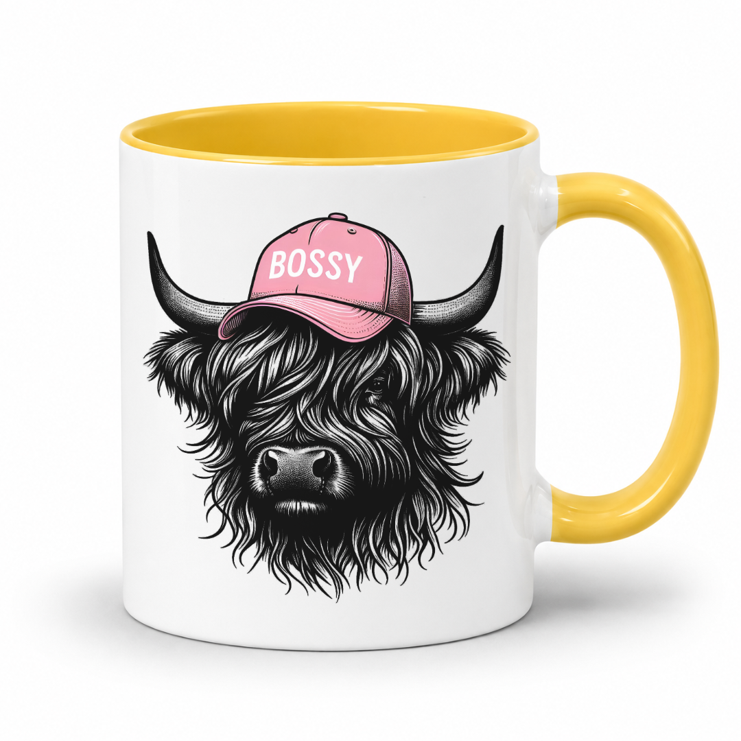 yellow handle and inner mug with an image of a black Bossy Highland Cow wearing a Pink Cap. Mug is set on a white background .grab your bossy  mug from Coffee and Moo NZ.