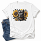 A white short-sleeve crewneck t-shirt featuring a graphic print of a black pitbull dog surrounded by yellow sunflowers and a gold bandana. The t-shirt is styled flat-lay with a pair of blue jeans on a clean white background. Grab your tee from coffee and moo NZ. 