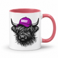 A white ceramic mug with a pink interior and handle, featuring a black-and-white illustration of a shaggy Highland cow wearing a purple cap with the word 'BOSSY' in white. Grab your bossy highland coo mug from Coffee and Moo NZ.