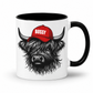 A white ceramic mug with a black interior, black handle, and a graphic of a shaggy Highland cow wearing a red baseball cap with the word 'BOSSY' in white, shown on a white background. Grab your Bossy highland coo mug from Coffee and Moo NZ.