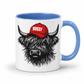 A white ceramic mug with a blue handle and interior, featuring a graphic of a shaggy black highland cow wearing a red cap with the word 'BOSSY' in white. Grab your Bossy highland coo mug from Coffee and Moo NZ.
