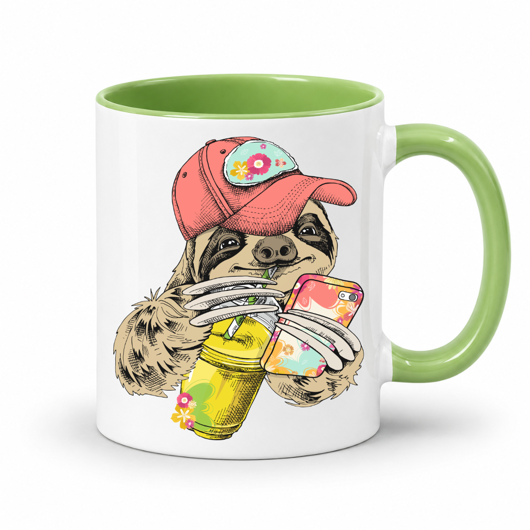 A white ceramic mug with a green interior and green handle, with a colorful illustration of a sloth wearing a coral coloured cap and holding a loaded-tea drink and a phone, set on a  white  background. Grab yours from Coffee and Moo NZ.