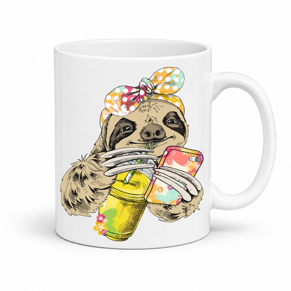 A white ceramic mug with a colorful illustration of a sloth wearing a polka dot bandana and holding a loaded-tea drink and a phone, set on a  white  background. Grab yours from Coffee and Moo NZ.