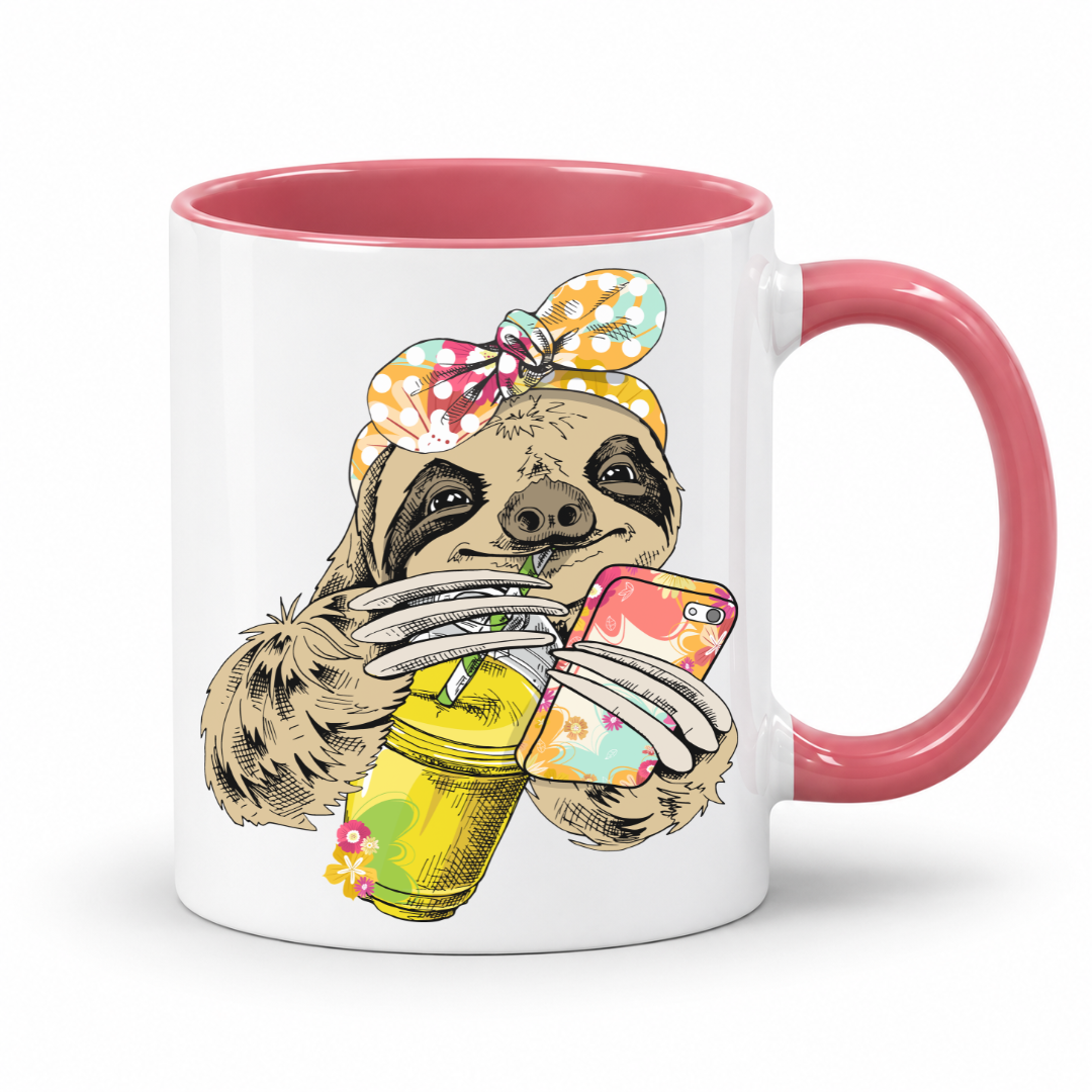 A white ceramic mug with a pink interior and pink handle, with a colorful illustration of a sloth wearing a polka dot bandana and holding a loaded-tea drink and a phone, set on a  white  background. Grab yours from Coffee and Moo NZ.